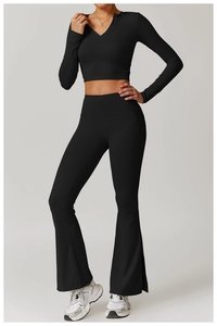 Detail view of black yoga set with slim fit long sleeve top and side slit flare pants