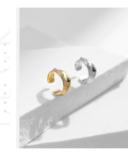 Detailed macro of S925 sterling silver ear cuffs with visible hallmark on textured stone
