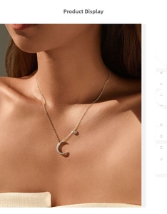 Detail of S925 sterling silver star and moon necklace with sparkling crystals on neck
