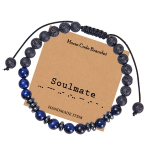 Detailed close-up of Soulmate Morse code bracelet with tiger eye stones and kraft card