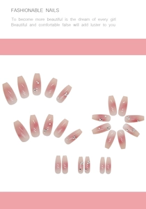 Detail of pink coffin press-on nails featuring blush gradient pearls and tiny rhinestones
