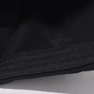 Detailed macro view of black fabric texture and edge stitching on outdoor baseball cap
