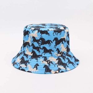 Detail showing high-quality vibrant blue fabric with printed horse silhouettes on bucket hat
