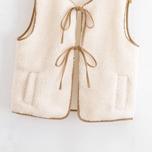 Women's fleece vest in cream white with brown contrast trim and front tie closure