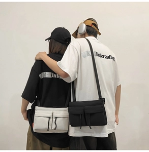Modern nylon messenger bag worn by a couple, showcasing its versatile and casual style