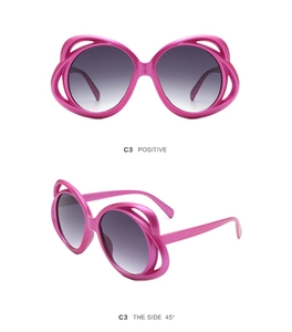 Front and side 45-degree views of oval rose pink sunglasses with hollow frame design