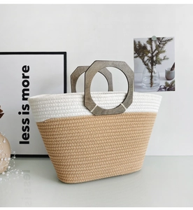 Detail of two-tone woven tote bag featuring unique octagonal wood handles and texture