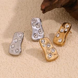 Abstract geometric 18K gold and silver stud earrings with sparkling white diamonds