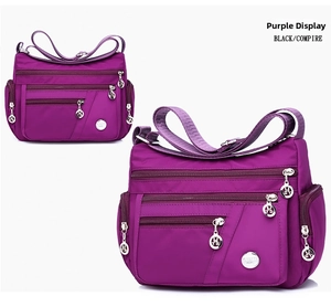 Detail view of purple waterproof nylon shoulder bag with multiple functional zippers
