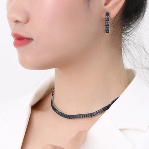 Detail of luxury zircon necklace and earrings set with black emerald-cut stones