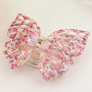 Detailed view of a 14cm butterfly hair claw clip with floral patterns on a light surface
