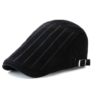 Detail of vintage black cotton ivy cap showing blue vertical stitching and metal buckle