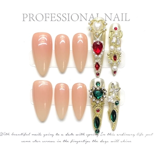 Luxurious handmade almond press-on nails with heart gems and gold butterfly charms
