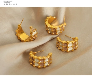 Detailed macro view of retro C-shaped earrings with checkered enamel and golden beads