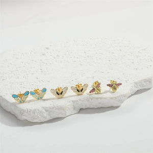 Minimalist gold butterfly and bee earrings with colorful enamel and crystal accents