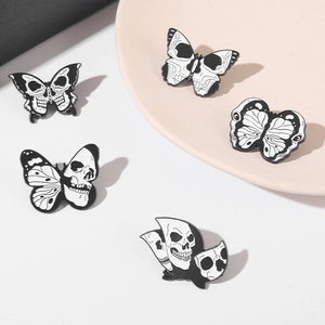 Detailed set of five skull butterfly enamel pins in black and white punk aesthetic