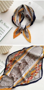 Detail of elegant pleated floral silk scarf with colorful geometric patterns and textures