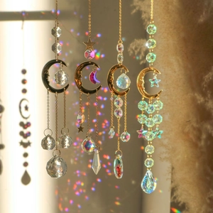 Detail of suncatcher hanging with crystal moon, stars, and rainbow light prisms decoration