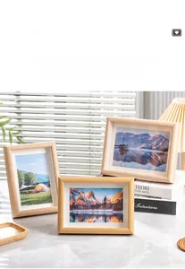 Detail view of light wood frames on marble surface with cozy home decor setting