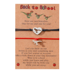 Detail of dinosaur charm bracelets for mother and daughter on back to school card