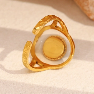 Macro detail of 18K gold plated ring featuring unique hammered metal texture and adjustable band