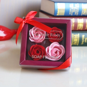Soap flower gift box with four red and pink roses, decorative ribbon, and silver lettering