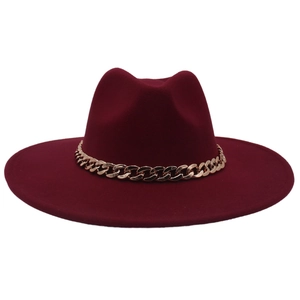 Detail of burgundy felt fedora featuring a wide brim and decorative chunky gold chain