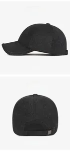 Detail of black winter baseball cap showing wool texture and adjustable metal buckle
