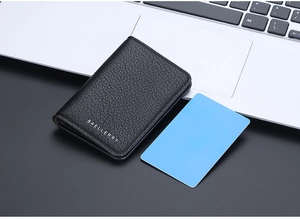 Detailed view of black litchi pattern leather wallet with silver brand logo