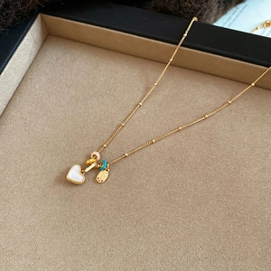 Detail of 18k gold plated heart pendant necklace with mother of pearl in a jewelry box