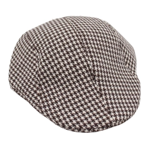 Close-up of brown houndstooth flat cap featuring textured tweed fabric and short brim