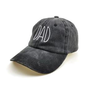 Detailed close-up of white DAD 3D embroidery on washed dark grey cotton baseball cap