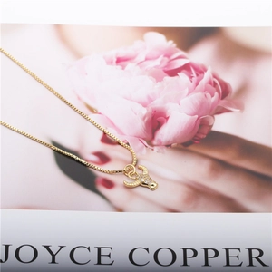 Golden zodiac ox pendant necklace with micro-pave crystals on a copper box chain