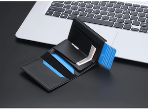 Macro view of slim RFID pop-up card wallet with black leather texture and metal frame