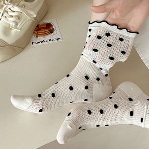 White hollow mesh crew socks with black polka dots and sweet ruffled lace cuffs for women