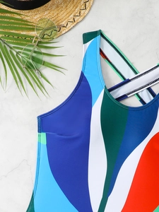 Close-up of color block swimsuit with geometric pattern and crisscross back straps