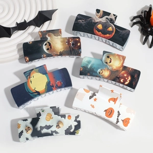 Halloween claw clip set with pumpkin and bat prints on minimalist white background