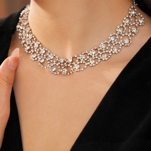 Close-up of sparkling rhinestone mesh necklace worn by a model in luxury palace style