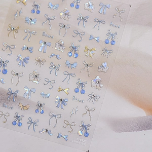 Iridescent blue bow and rabbit nail art stickers with shimmering rhinestones and stars