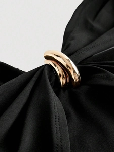 Slim fit black cropped top with chic gold buckle detail and stylish cross straps
