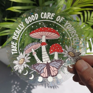 Holographic mushroom suncatcher sticker with Take Care Of Yourself text detail