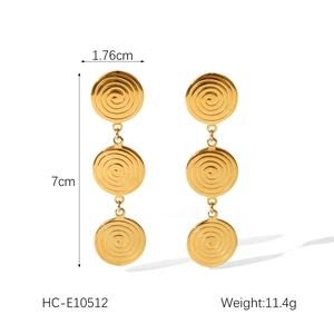 Detailed view of triple-disc spiral drop earrings in 18k gold-plated stainless steel