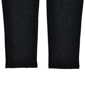 Close-up of black long sleeve jumpsuit cuffs with subtle glitter texture and fine fabric detail