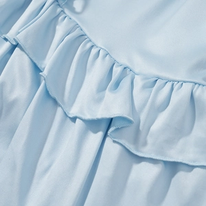Close-up of light blue bohemian dress showing ruffle details and chiffon fabric texture