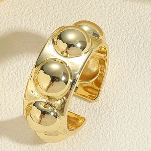 Detail shot of the 14K gold plated brass ring featuring polished round rivet studs