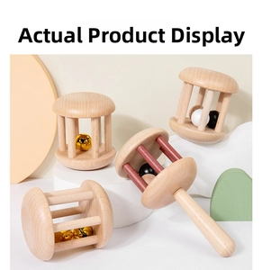 Close-up of four natural wooden baby rattles showing smooth texture and craftsmanship