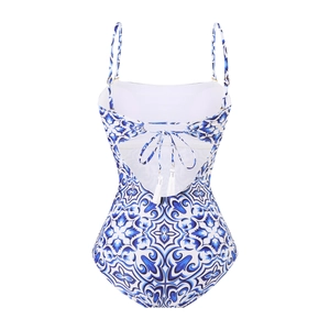 Detail of blue majolica print swimsuit featuring back cross straps and white tassels