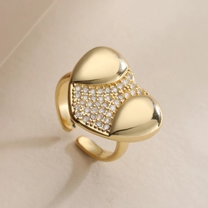 18K gold plated copper heart ring with cubic zirconia on a minimalist beige background