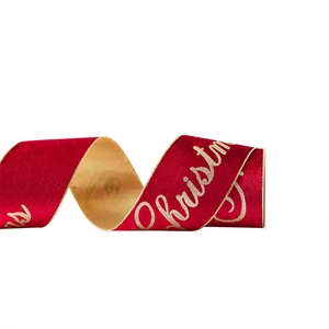 Red velvet ribbon with gold Merry Christmas lettering and golden reverse for decoration