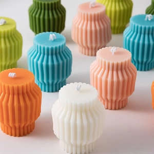 Detailed group view of colorful geometric pillar candles with unique vertical stripes